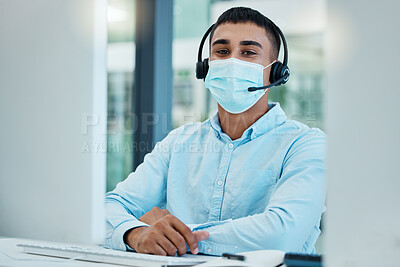 Buy stock photo Call center, consultant and covid face mask at desk of telemarketing, CRM and customer support agent at office for help and advice. Male with headset for contact us service on website during covid 19