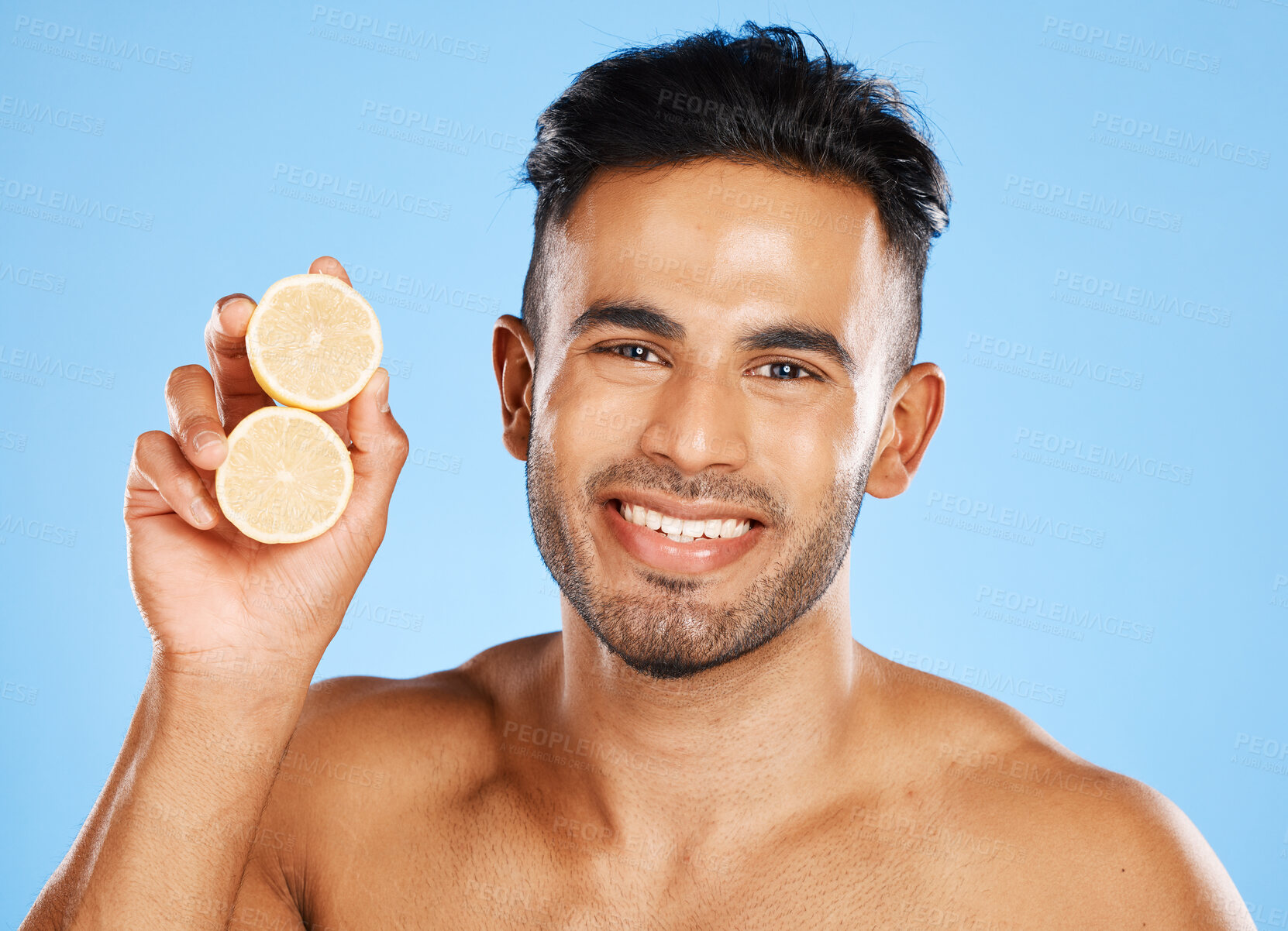 Buy stock photo Health, lemon and skincare for man with citrus fruit for facial, vitamin c and wellness with a smile on blue background. Dermatology, beauty and healthy food portrait for clean, glow and skin healthy