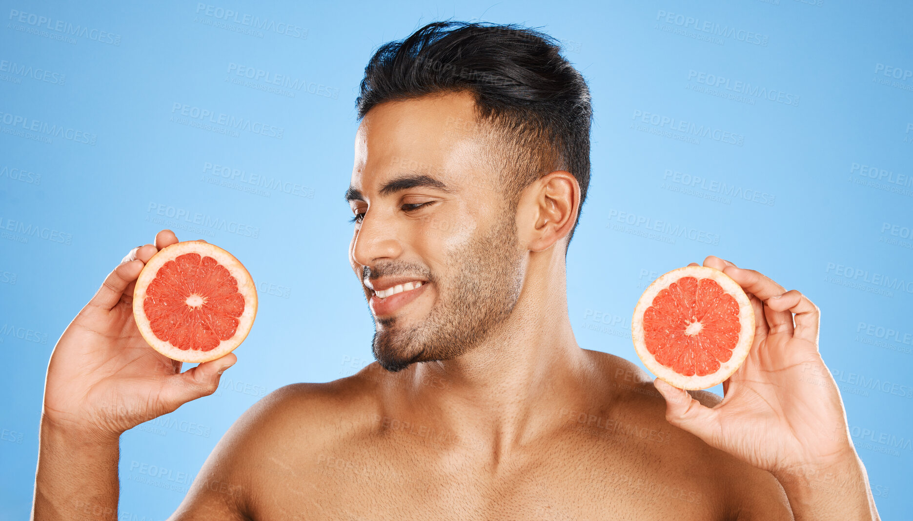 Buy stock photo Man, face and grapefruit healthy skincare wellness glow vitamins. Young person model happy smile, luxury orange fruit beauty lifestyle and cosmetic skin detox body treatment in blue background studio