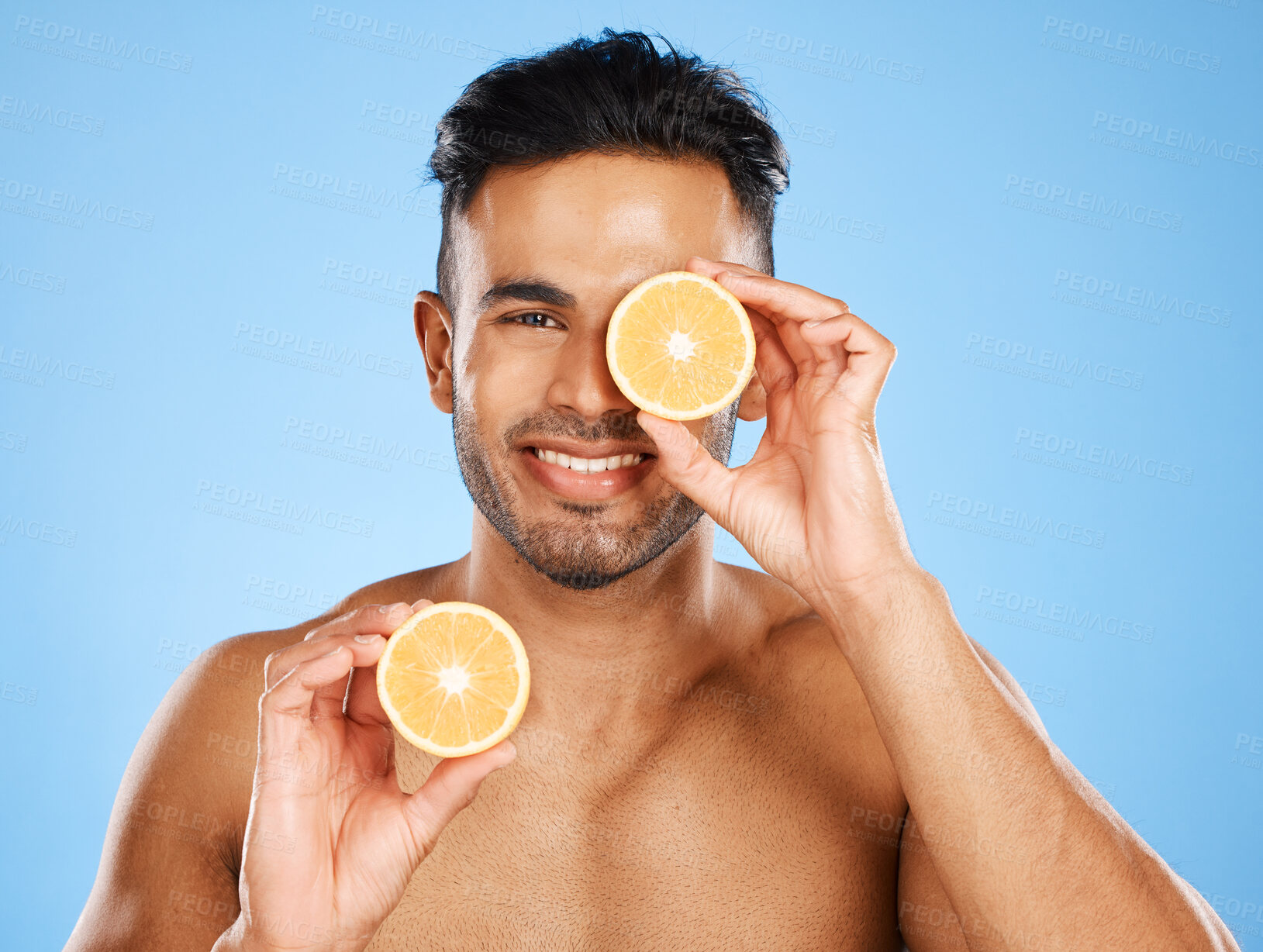 Buy stock photo Vitamin C, lemon and male skincare portrait for healthy, glowing face skin on studio background. Health, wellness and citrus treatment for smooth and natural skin care on a blue backdrop