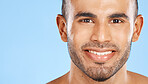 Skincare, portrait and man in studio for beauty, teeth and wellness against a blue background mockup. Face, cleaning and skin by model happy, smile and relax during grooming, hygiene and body care