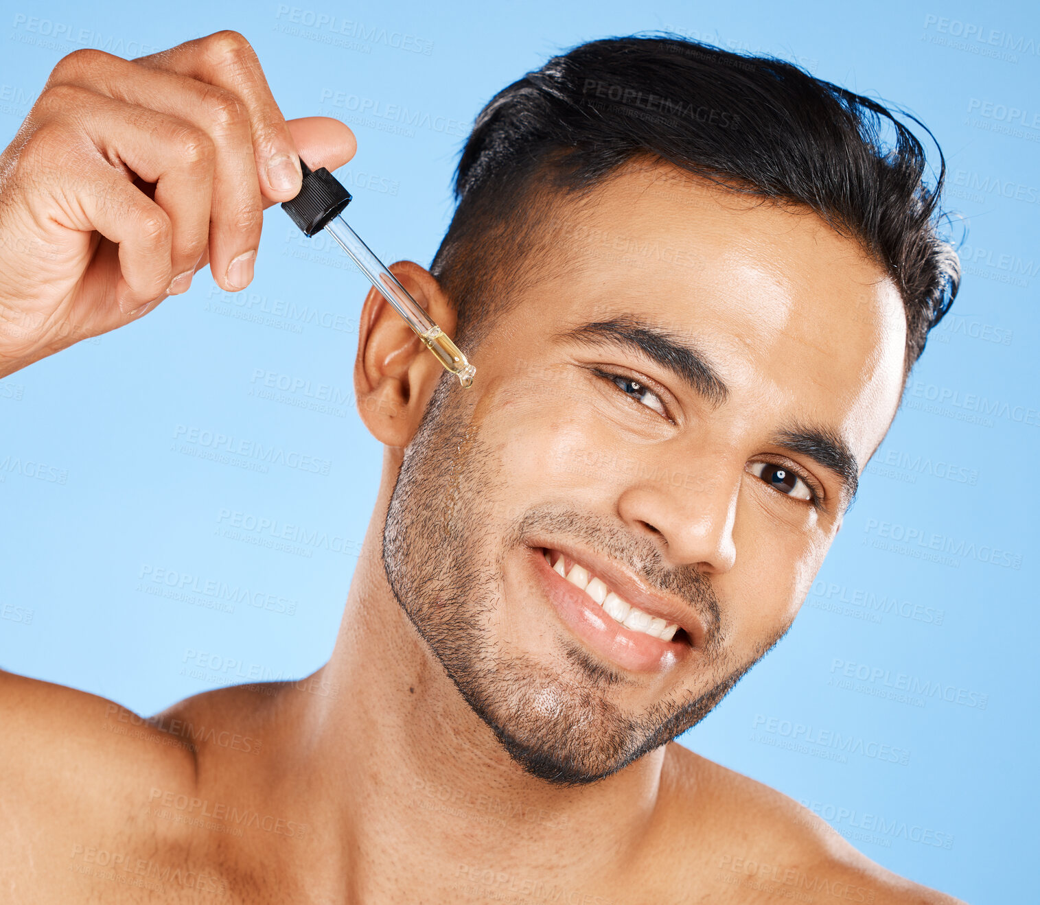 Buy stock photo Man face, skin serum or beard oil of facial hair growth beauty product on blue studio background. Portrait of a happy young arab guy model, liquid dermatology and hyaluronic acid for body cosmetics 