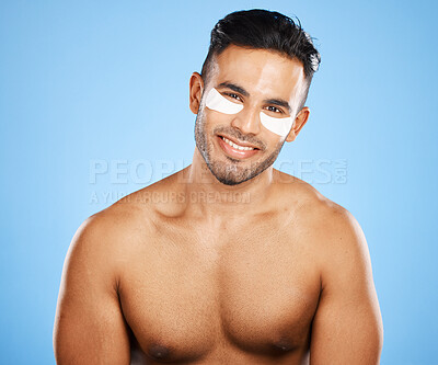 Buy stock photo Man, skincare and eye care, cosmetic and grooming, eye mask and facial treatment portrait with blue studio background. Beauty, face and healthy skin, body wellness and cosmetology advertising.