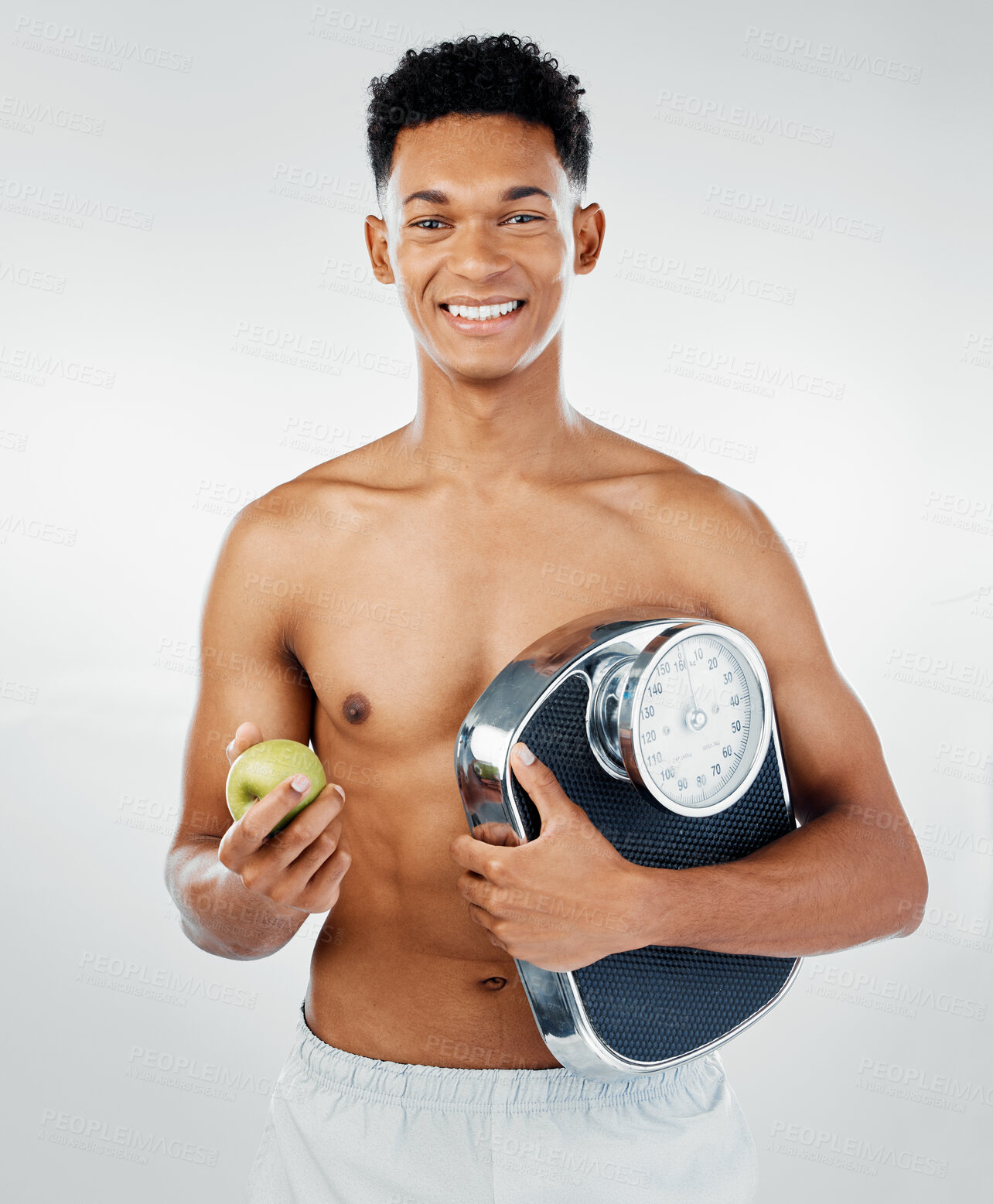 Buy stock photo Apple, man and scale for health, fitness and diet in studio against white background mockup for weight loss. Fruit, training and wellness model with black man happy, smile and relax with nutrition