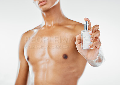 Buy stock photo Beauty, skincare and perfume with body of man for luxury, spray and fragrance cosmetics. Hygiene, clean and lifestyle with model against white background in studio for smell, elegant and sensual