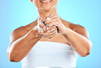 Hands, cleaning and woman washing hands in studio for health, hygiene and safety from bacteria against blue background. Hand, wellness and germ prevention by model with soap, bubble and foam product