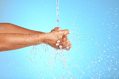 Buy stock photo Hands, water and wash for clean hygiene, health or wellness against a blue studio background. Hand rinsing, washing or cleaning for fresh hygienic cleanse or hydration in care for skin on mockup