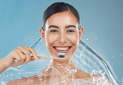 Buy stock photo Woman brushing teeth, water splash and toothbrush, toothpaste and dental cleaning of mouth wellness on blue background in studio shower Portrait face of healthy teeth, big smile or facial beauty care