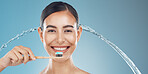 Woman brushing teeth, water splash and wellness, dental cleaning and mouth cosmetics on blue background in shower. Happy young model face portrait, toothpaste on toothbrush and healthy teeth smile 