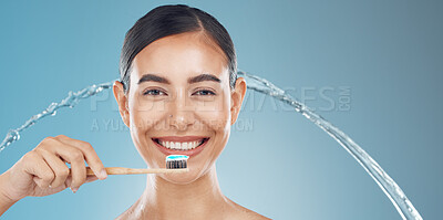 Buy stock photo Woman brushing teeth, water splash and wellness, dental cleaning and mouth cosmetics on blue background in shower. Happy young model face portrait, toothpaste on toothbrush and healthy teeth smile 