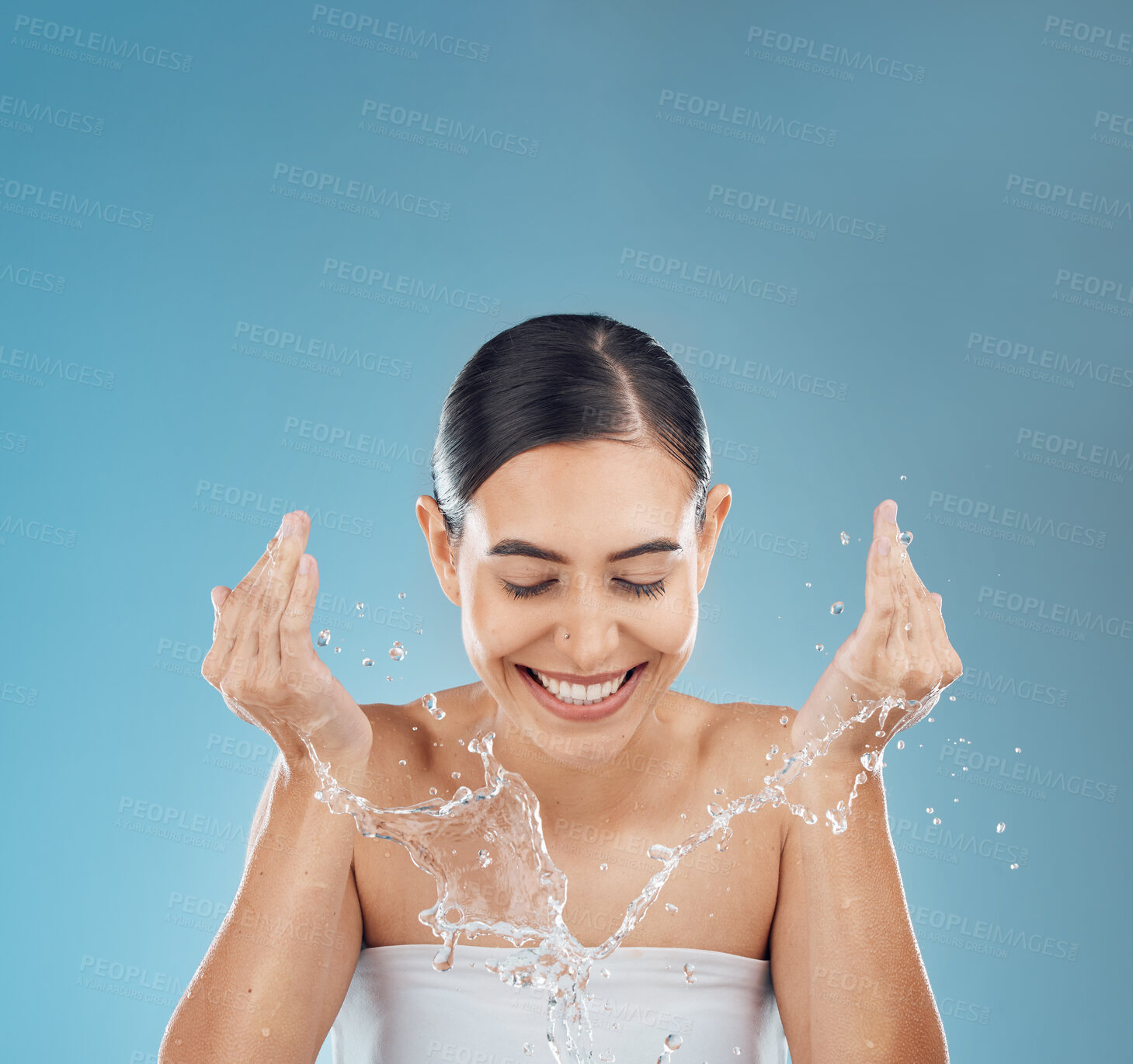Buy stock photo Woman water splash face, cleaning and wellness, shower and glowing skincare on mockup studio blue background. Happy young girl facial beauty, water drop and washing face, natural body and self care