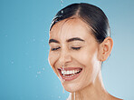 Beauty, woman face and water of a person feeling skincare, health and wellness for a morning routine. Shower of a young model with cosmetic, natural beauty and facial wash feeling happy with a smile 