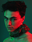 Beauty, skincare and snake by man in neon, light and color  studio for aesthetic, style and cosmetic. Portrait, face and animal by model for facial, product and glamour by asian on neon green mockup