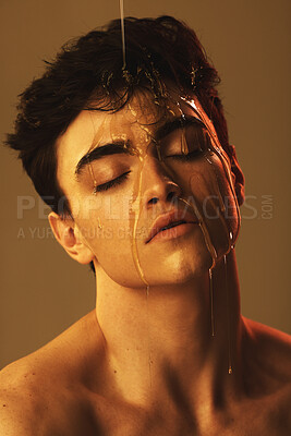 Buy stock photo Honey, dripping and man face for beauty and skincare with food and liquid. Beautiful model person from Spain head with a relaxing facial expression with a creative, cosmetic art and artistic drip 