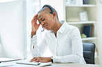 Black woman, headache and stress in call center by computer for consulting in customer service at the office. African American female suffering from burnout, depression or anxiety in telemarketing