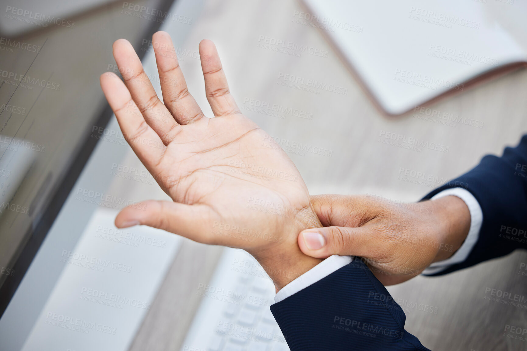 Buy stock photo Business hands, pain and wrist on computer from working, discomfort or ache at the office. Employee hand suffering from carpal tunnel syndrome or injury holding painful or sore area at the workplace