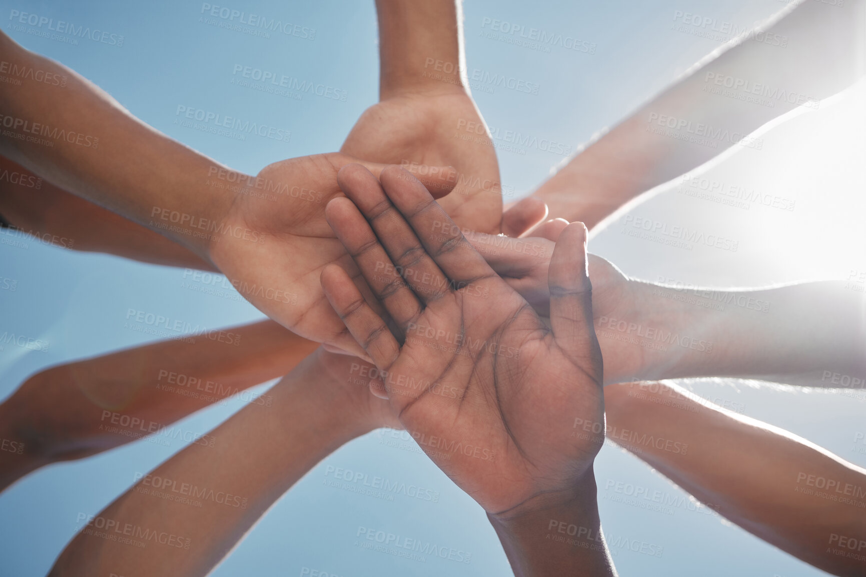 Buy stock photo Hands, team and community below in support, trust or collaboration against a blue sky background. Group hand of people together in teamwork, meeting or partnership for unity, agreement or motivation