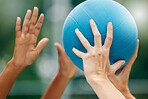 Netball, sport and athlete hands with ball, game and challenge on a court in urban city park outside. Women, sports fitness and healthy lifestyle wellness training outdoor during training or practice