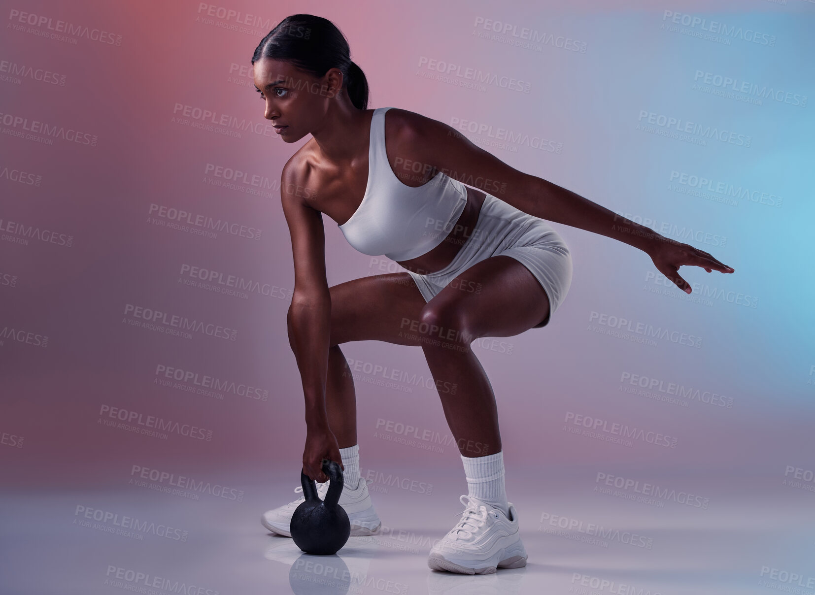 Buy stock photo Fitness, kettlebell and woman training in studio for full body balance, powerful muscles and strong arms. Sports, exercise and healthy Indian girl swinging weights or weightlifting in a squat pose