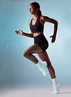 Buy stock photo Fitness, health and black woman running in studio with blue background. Sports, exercise and form, motivation for strong runner cardio training for a marathon or race, workout for woman from Jamaica.