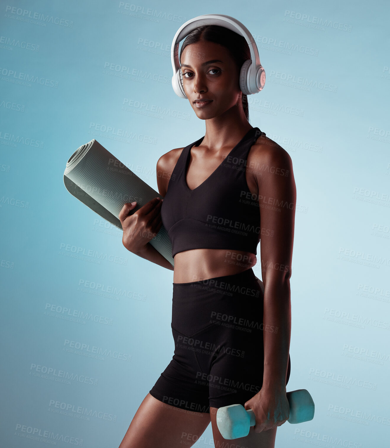 Buy stock photo Headphones, fitness and exercise woman in studio with dumbbells and yoga or cardio gear for workout wellness, exercise or training fashion portrait. Black woman with sports  music and health mock up