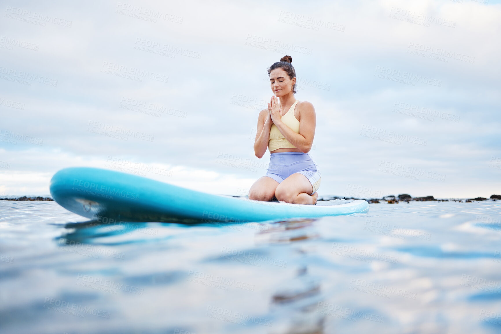 Buy stock photo Yoga meditation, ocean and surfer woman meditating for health wellness, peace or freedom on sea water. Surfboard pilates, prayer and zen girl meditate for beach fitness, aura or chakra energy healing