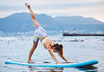 Woman, surfboard or water yoga on ocean or sea in relax workout, training or exercise for core balance, health or wellness. Zen, calm or peace person on paddle board in nature fitness or body pilates