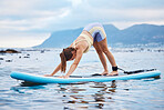 Surfer woman, surfboard and pose on water, beach and yoga practice for peace, wellness and calm. Female, surf and meditation seaside for workout, training and exercise outdoor for health and fitness.