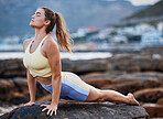 Meditation, yoga stretching and woman on rock at beach for mindfulness peace exercise, spiritual healing and wellness training to relax. Zen workout, outdoor lifestyle and pilates for health fitness 