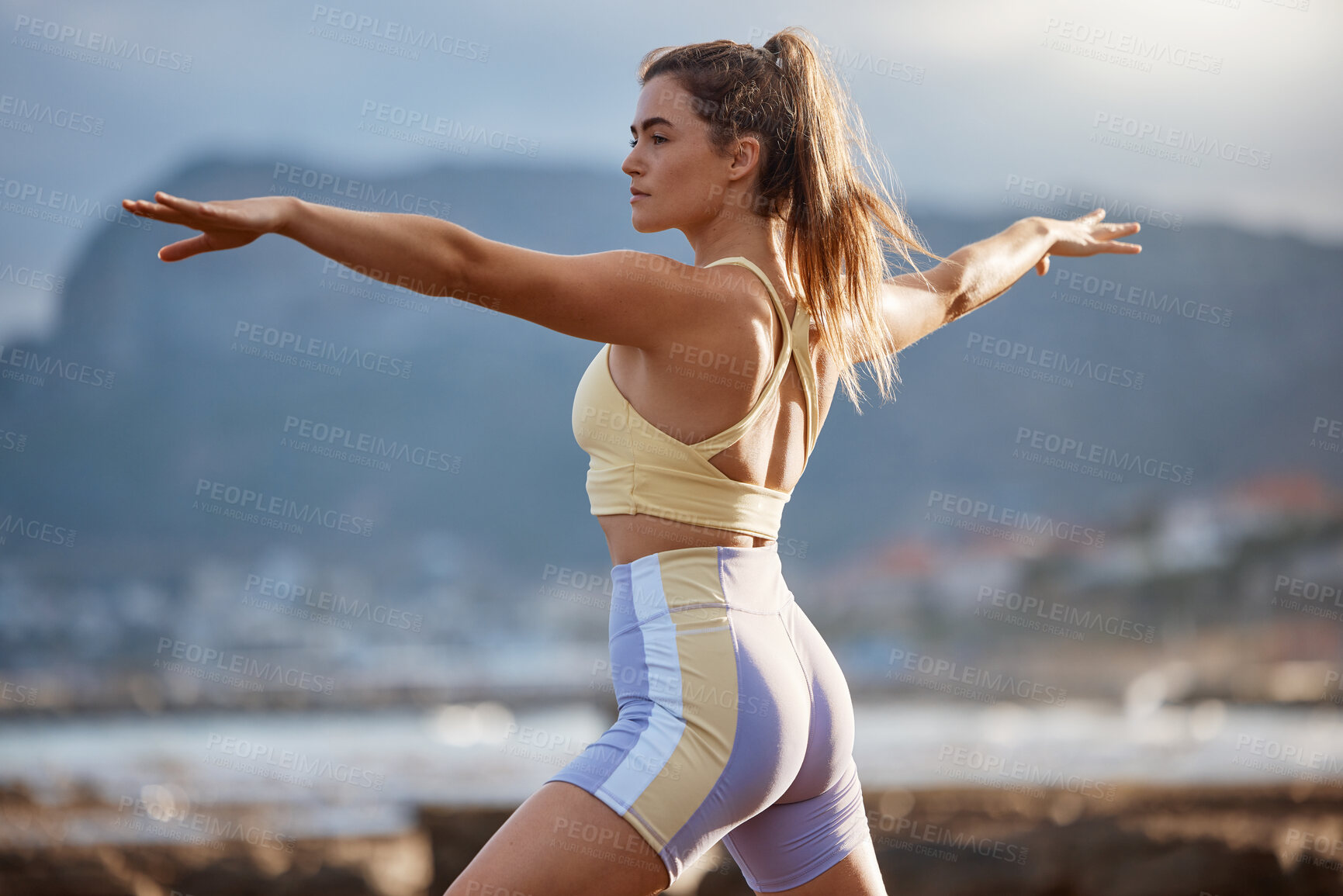 Buy stock photo Yoga, outdoor exercise and stretching woman doing nature pilates for wellness, body and mental health in the city. Fitness female at beach for zen, calm and spiritual workout for a healthy lifestyle