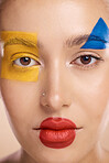 Beauty, art and portrait of woman paint on face, creative makeup and self expression. Skincare, creativity and color block shape cosmetics, empowerment and freedom to express for young beautiful girl