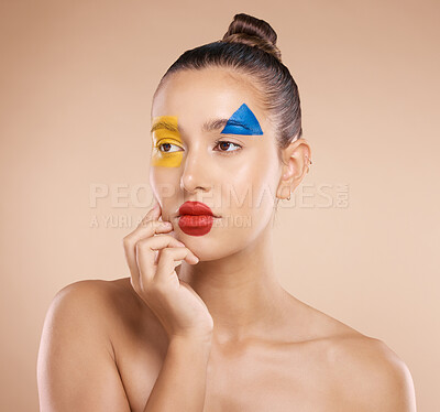 Buy stock photo Beauty, art and portrait of woman paint on face, creative makeup and serious self expression. Skincare, creativity and hand touching cheek with artistic color shape cosmetics on young beautiful girl.