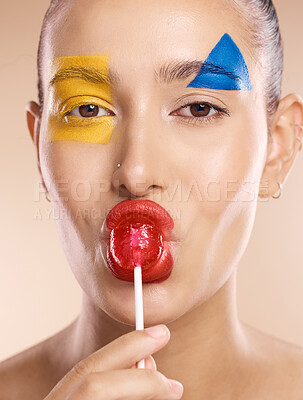 Buy stock photo Beauty paint, face art and woman with creative makeup design, skincare or luxury facial cosmetics. Color creativity, lollipop and portrait of aesthetic model girl with red, blue and yellow shapes