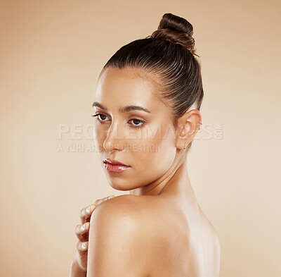 Buy stock photo Face, beauty and skincare with a model woman posing in studio on a beige background for health or body care. Wellness, luxury and cosmetics with an attractive young female posing fo natural treatment