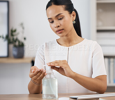Buy stock photo Business woman sanitizing her hands in an office for hygiene, stop germs and protection. Hand sanitizer, clean and corporate employee from Mexico with coronavirus safety compliance in the workplace.