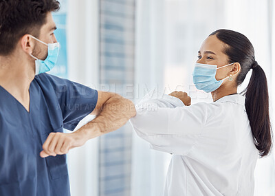 Buy stock photo Doctors, elbow greeting and covid safety in social distancing, compliance or regulations at the hospital. Medical professionals greet with arms for health and safety during pandemic at the workplace