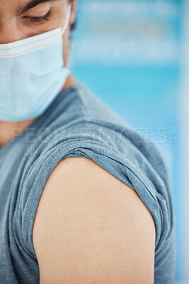 Buy stock photo Man, shoulder and waiting for covid vaccine, injection or syringe for appointment at the clinic. Male getting ready for vaccination to combat the virus, disease or illness for checkup at the hospital
