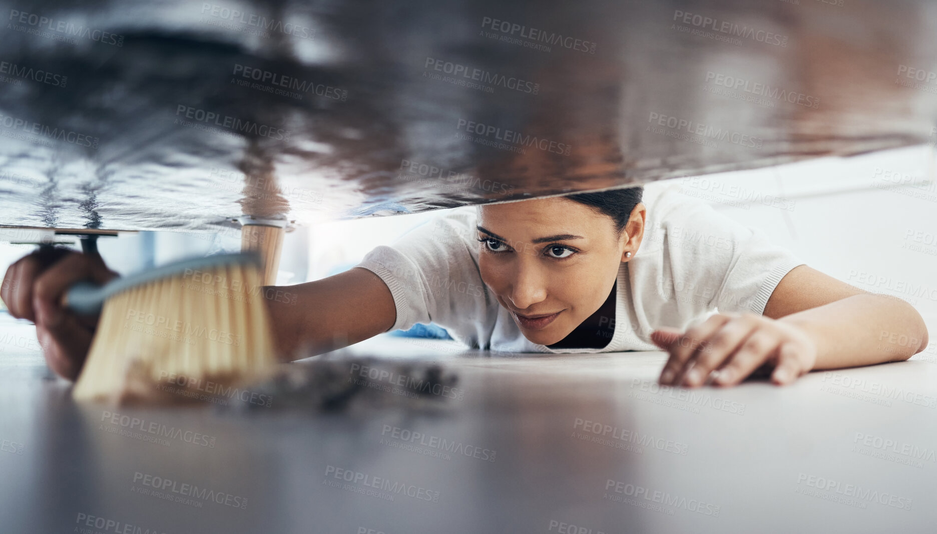Buy stock photo Woman, hand broom or sweeping dust in house, home or hotel bedroom in housekeeping cleaning, cleaner service or hygiene maintenance. Brush, dirty or messy floor spring cleaning under hospitality sofa