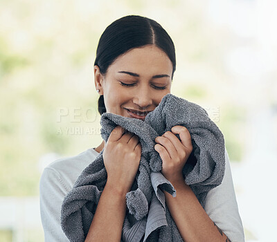 Buy stock photo Laundry, fresh and woman smelling clean clothes with a smile, peace and calm in a house. Happy, young and smiling cleaner cleaning clothing, linen and towel in the morning with happiness in a home