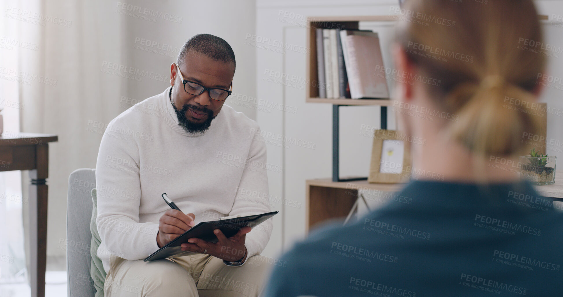 Buy stock photo Black man, psychology and writing note with woman patient in counseling appointment for help, support and consulting. Psychologist listening, advice and helping client with mental health or anxiety