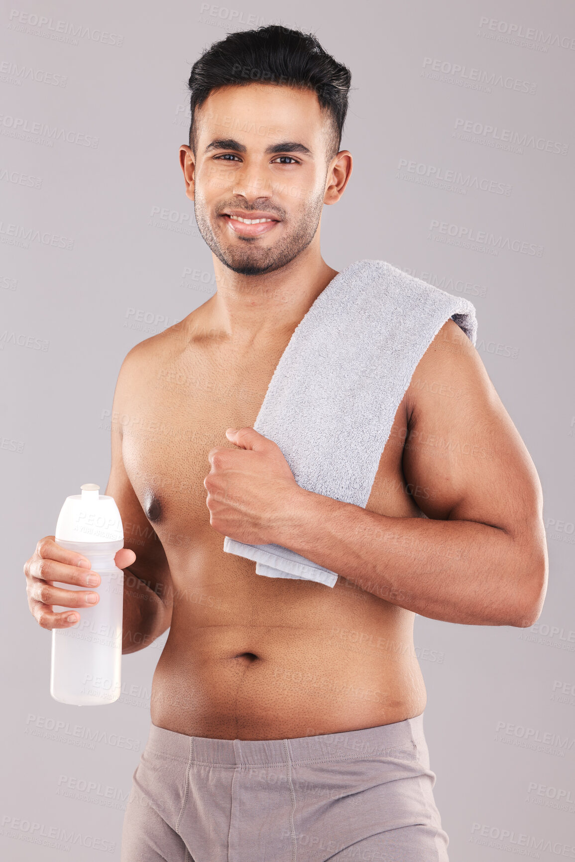 Buy stock photo Fitness, exercise and portrait of man with towel on shoulders for wellness, sports and workout. Healthy lifestyle, training and young male with water bottle in hand isolated on gray background studio