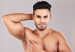 Beauty, portrait and skincare man with hand on muscular chest satisfied with body care for cosmetic advertising. Happy male model with muscles flexing healthy skin with mockup in grey studio.
