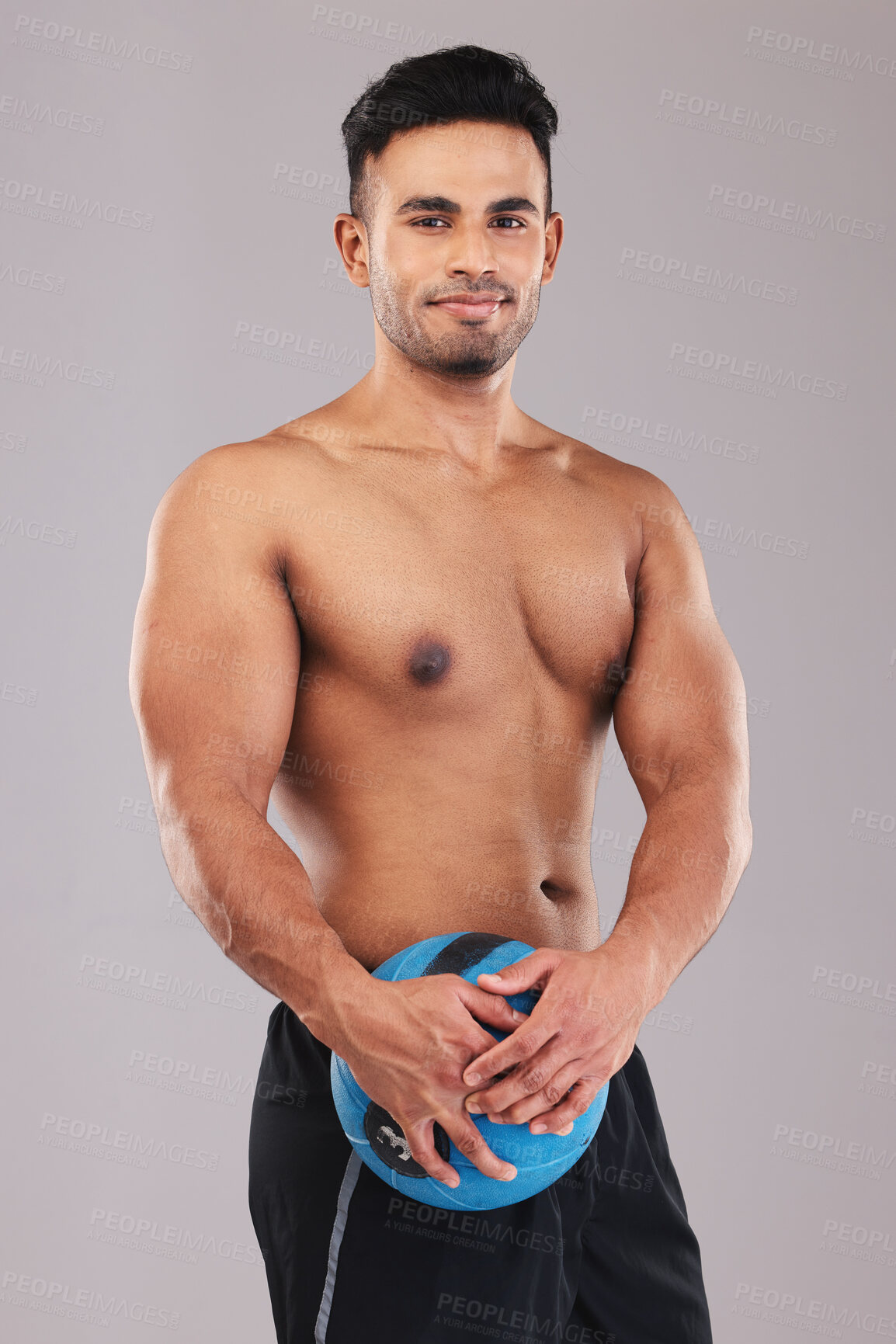Buy stock photo Fitness, portrait and man with a medicine ball for sports, workout and exercise against a grey studio background. Wellness, training and portrait of a young Arab athlete happy with body cardio