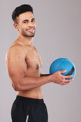 Buy stock photo Fitness, health and man with a ball for training, workout and sports against a grey mockup studio background. Happy, cardio and portrait of a young athlete with a smile for exercise and health