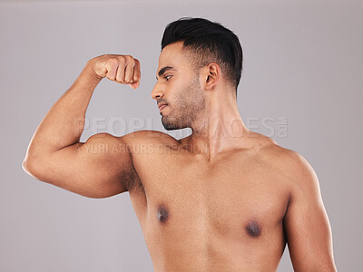 Buy stock photo Muscle, arm and man strong from training for health, goal and body against a grey mockup studio background. Power, pride and athlete with bicep to show progress with workout, exercise and fitness