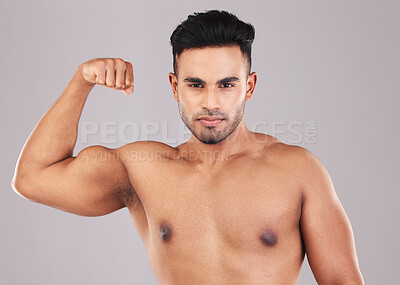 Buy stock photo Fitness, portrait and man flexing his bicep for motivation, energy and power in a studio. Wellness, health and athlete from Mexico with strong arm muscles after training isolated by a gray background