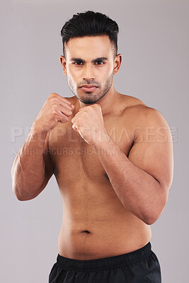 Buy stock photo Fist, fight and portrait of an athlete in a studio for sports, MMA or martial arts training. Fitness, defense and strong fighter ready to do a boxing exercise or workout isolated by a gray background