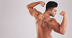 Muscle, strong and man flexing arms with training progress against grey mockup studio background. Fitness, wellness and back of athlete bodybuilder with power and bicep from exercise and workout