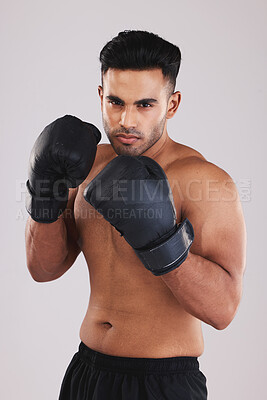 Buy stock photo Boxing gloves, portrait and man training in sports fight, challenge or mma competition on studio background. Strong, focus and fitness guy, professional boxer champion and bodybuilder, fist and power