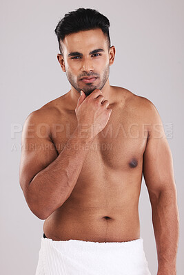 Buy stock photo Skincare, health and body of a man after a shower, grooming and hygiene against a grey studio background. Motivation, wellness and young Arab model thinking of care for skin, cosmetics and beauty
